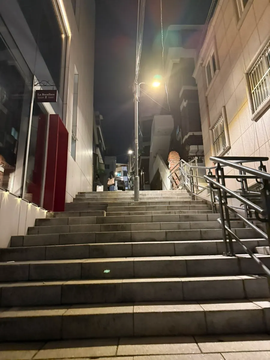 Exterior of the white building in Haebangchon that houses Cove Bar