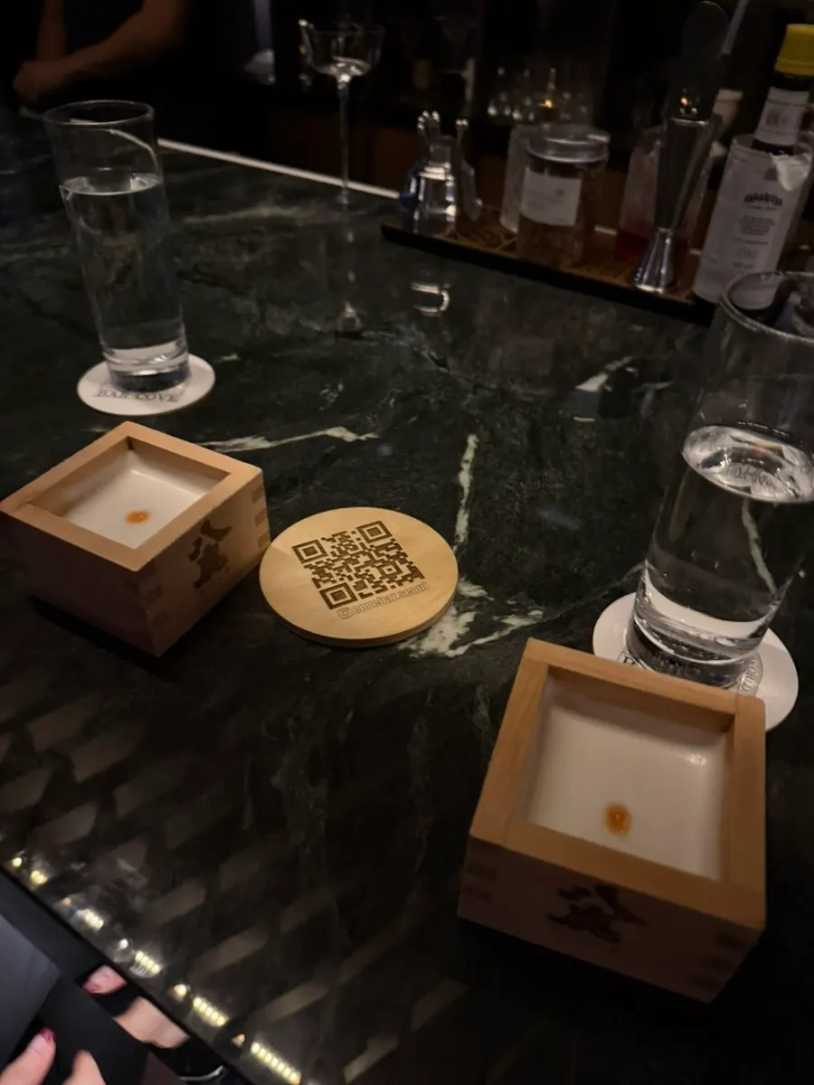 A cocktail set against Cove Bar's ambient lighting