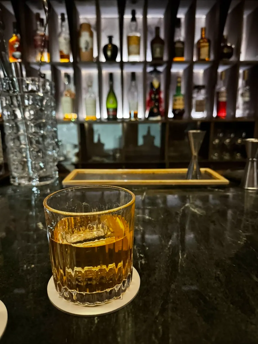 A cocktail glass by the bar counter at Cove Bar