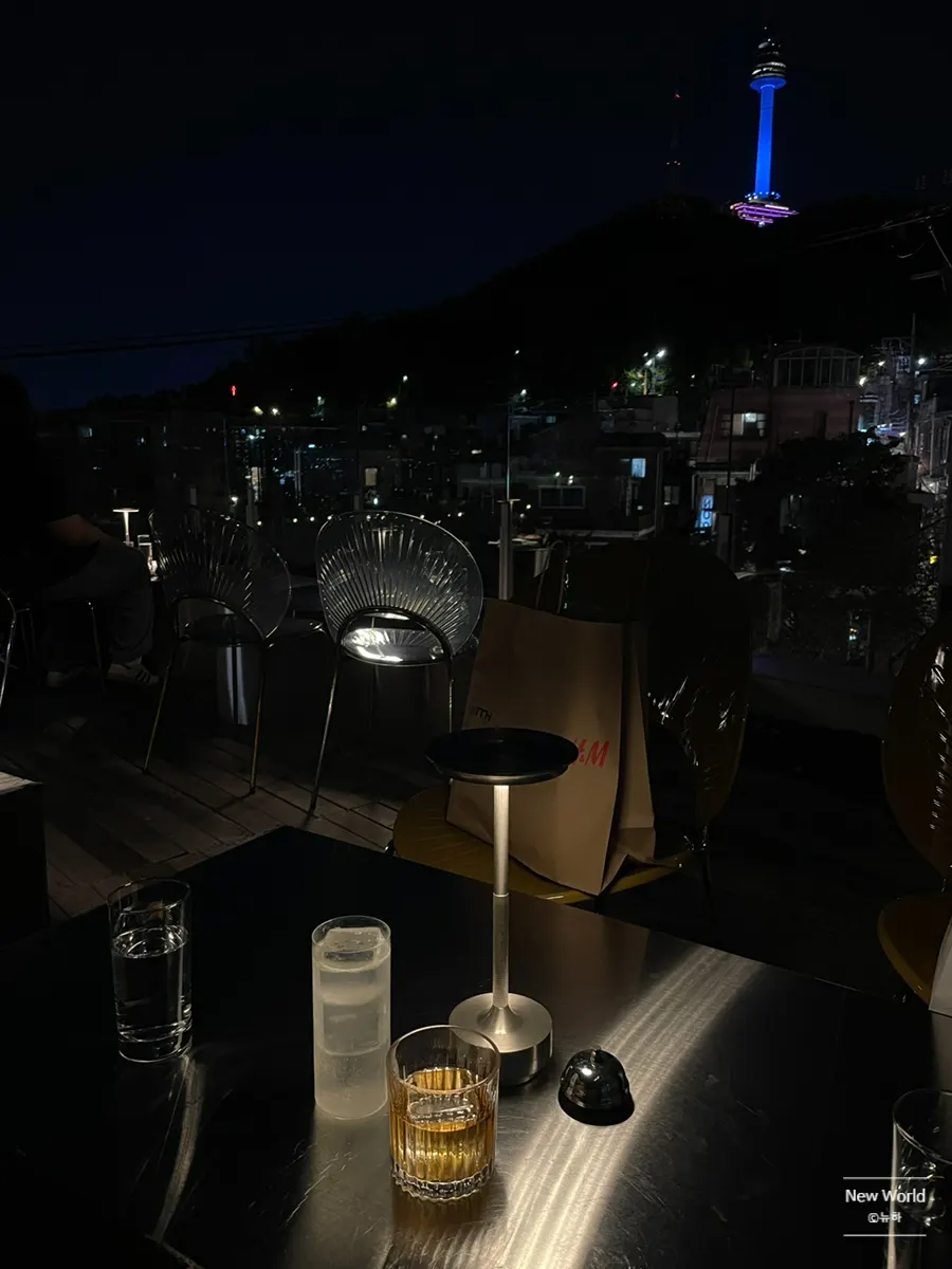 An Old Fashioned cocktail set against the night view