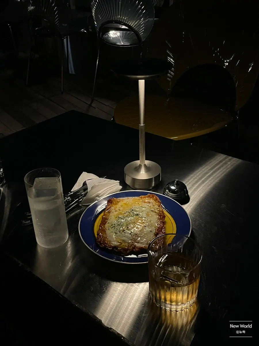 Lasagna and a cocktail set on the rooftop table