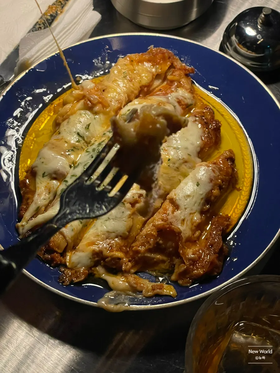 Cross-section of lasagna full of ragu sauce and cheese