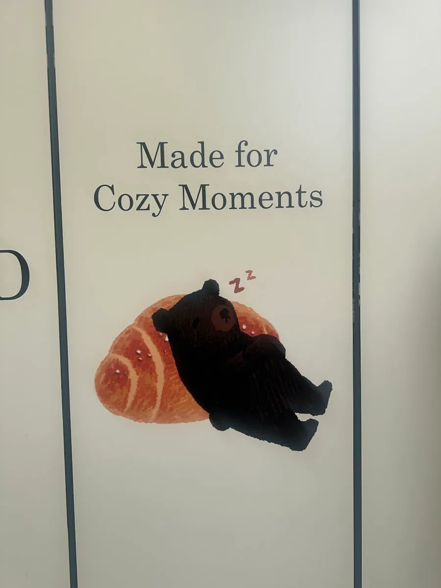 Bear character sign in front of Cozy Bear