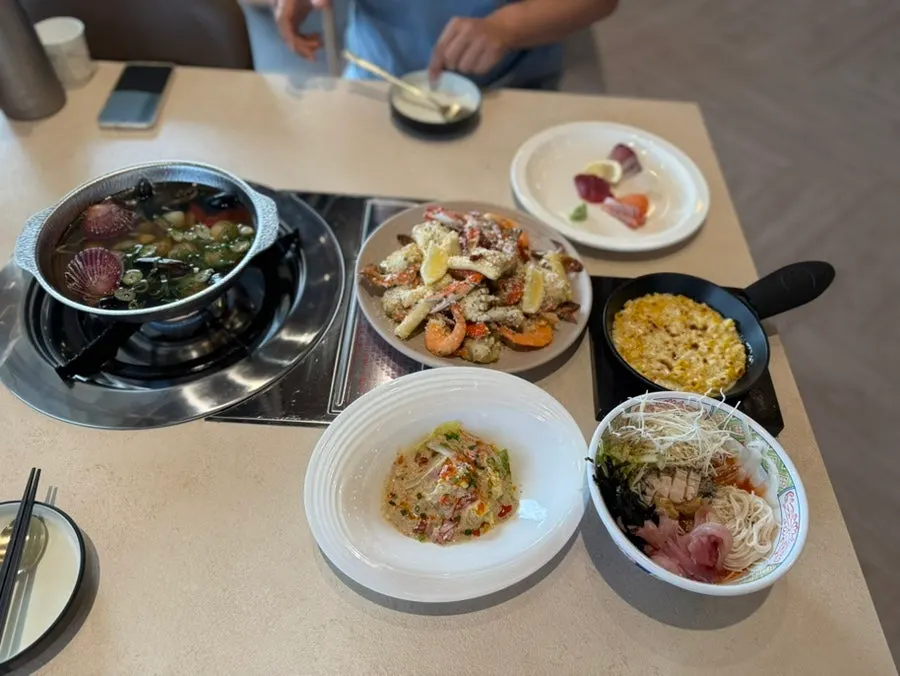 Table set with honey butter crab rice cake, mulhoe, and sashimi together