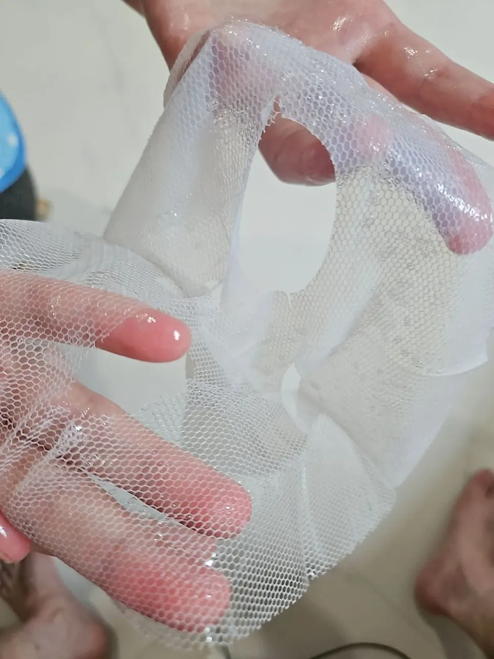 Applying the sheet to the face along its contours after cleansing