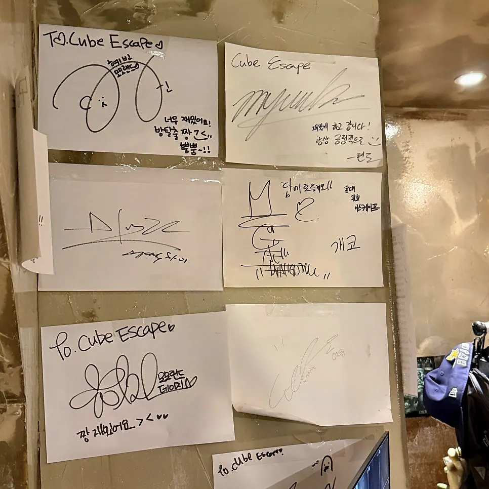 Wall by the counter covered in signed papers