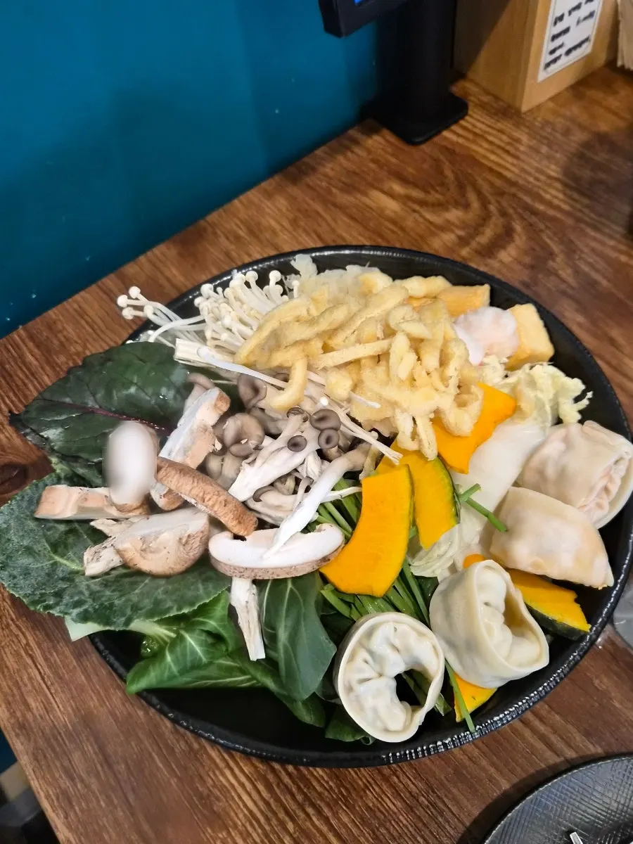 Split pot of clear broth and seafood broth
