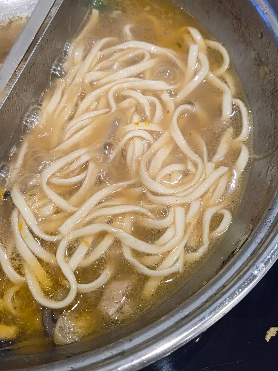 Kalguksu noodles cooked in leftover broth