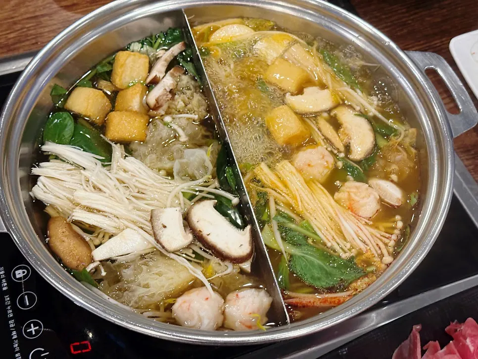 Shabu-shabu pot boiling with vegetables and beef
