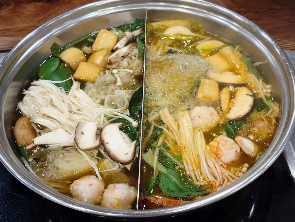 A table piled high with vegetables and beef for shabu-shabu