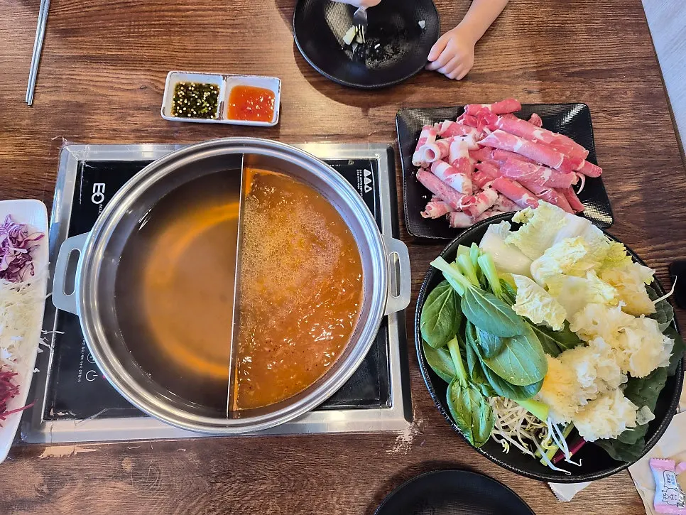 Shabu-shabu pot with half clear, half spicy broth