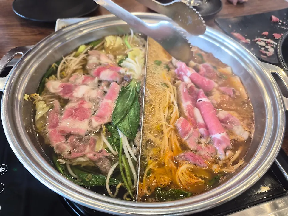 Vegetables and beef cooking in the spicy broth