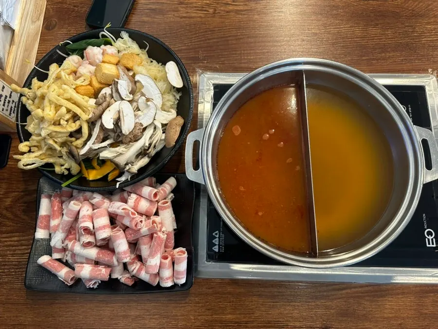Pot of half-and-half broth heating on the burner