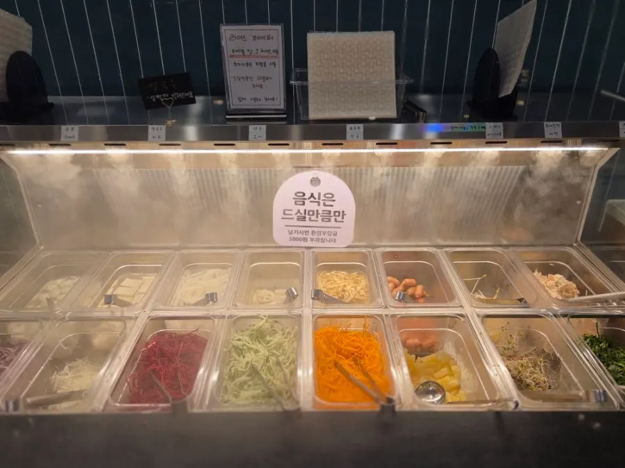 Cafeteria bar displaying over 40 kinds of vegetables