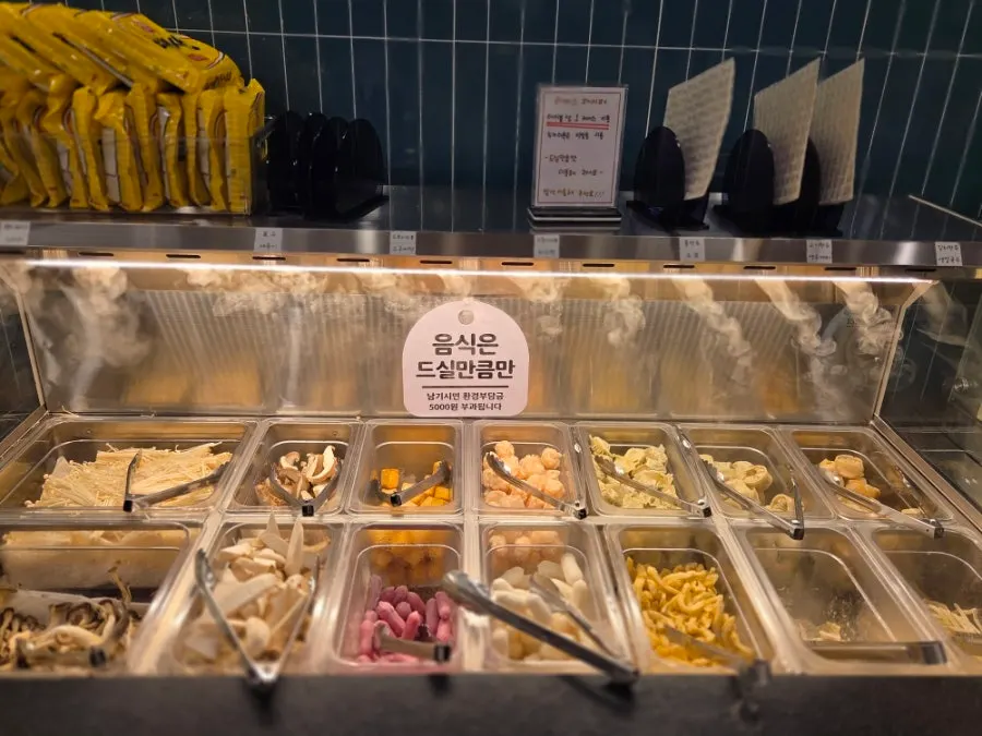 Self-serve bar with shabu-shabu vegetables and sauces