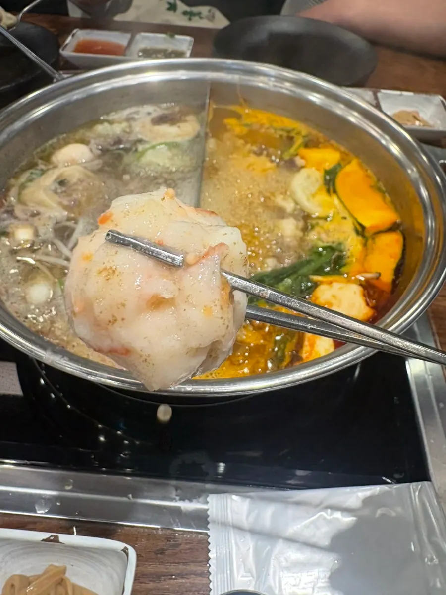A bowl filled with cooked meat and vegetables