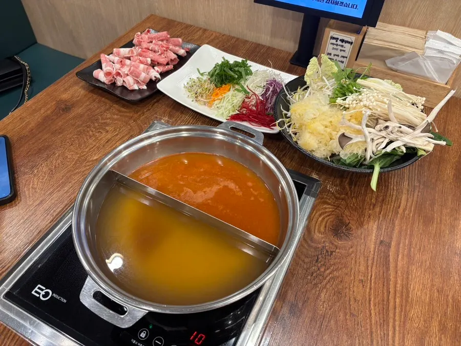 Pot filled with half seafood, half spicy broth