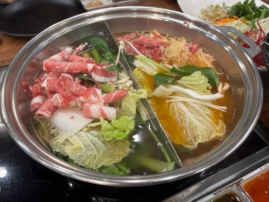 Shabu-shabu pot filled with vegetables and beef