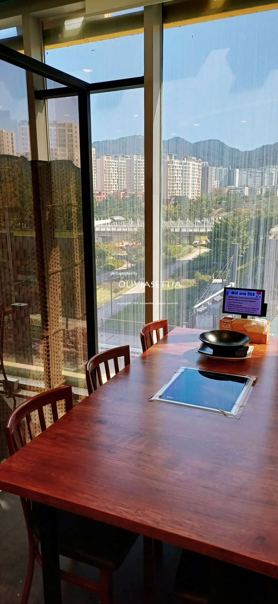 Interior of the reservation room with a floor-to-ceiling view of Changgokcheon Stream
