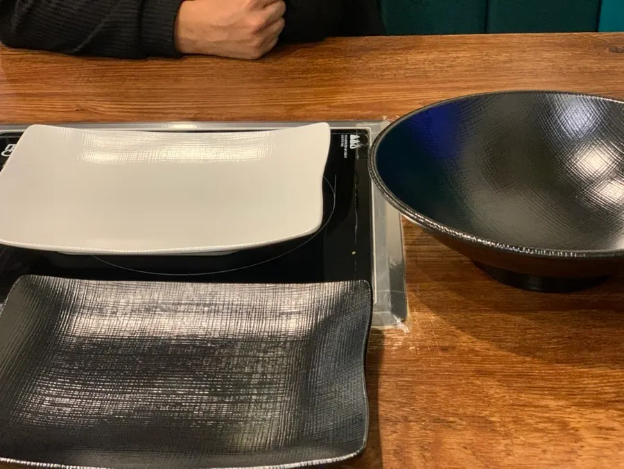 Table set with a shabu vegetable bowl and meat plate