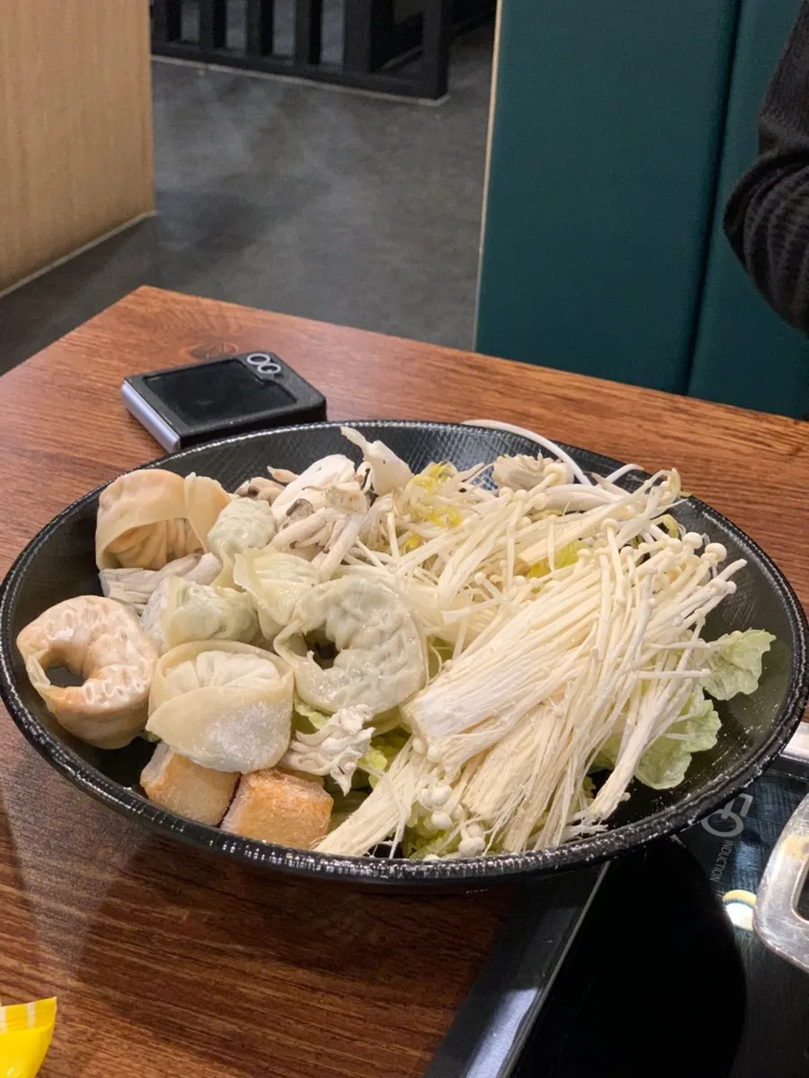 A plate piled high with shabu vegetables and mandu