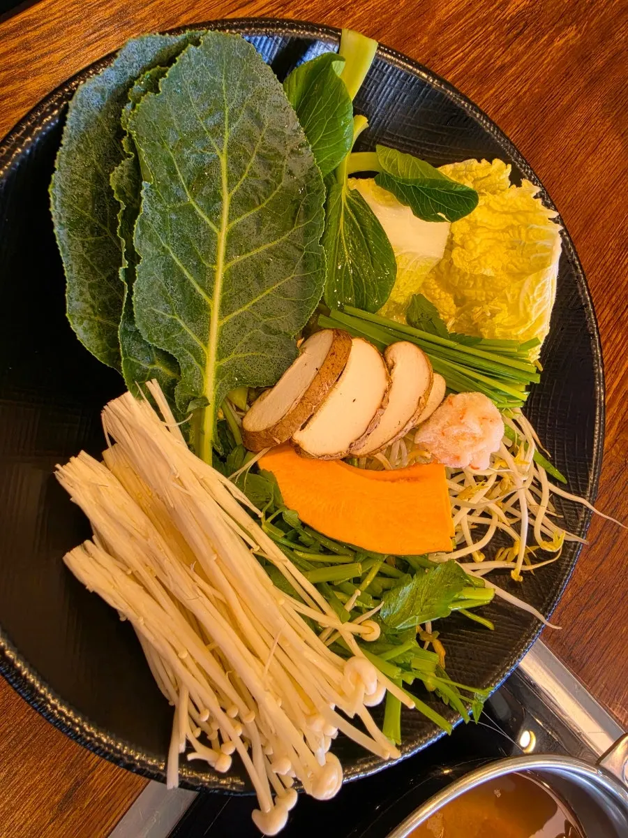 A plate of vegetables and mushrooms brought back to the table