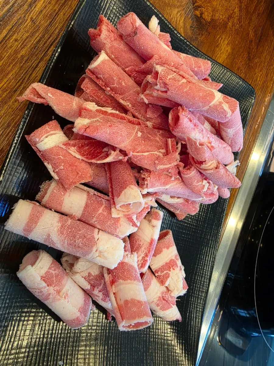A self-served plate of shabu-shabu meat
