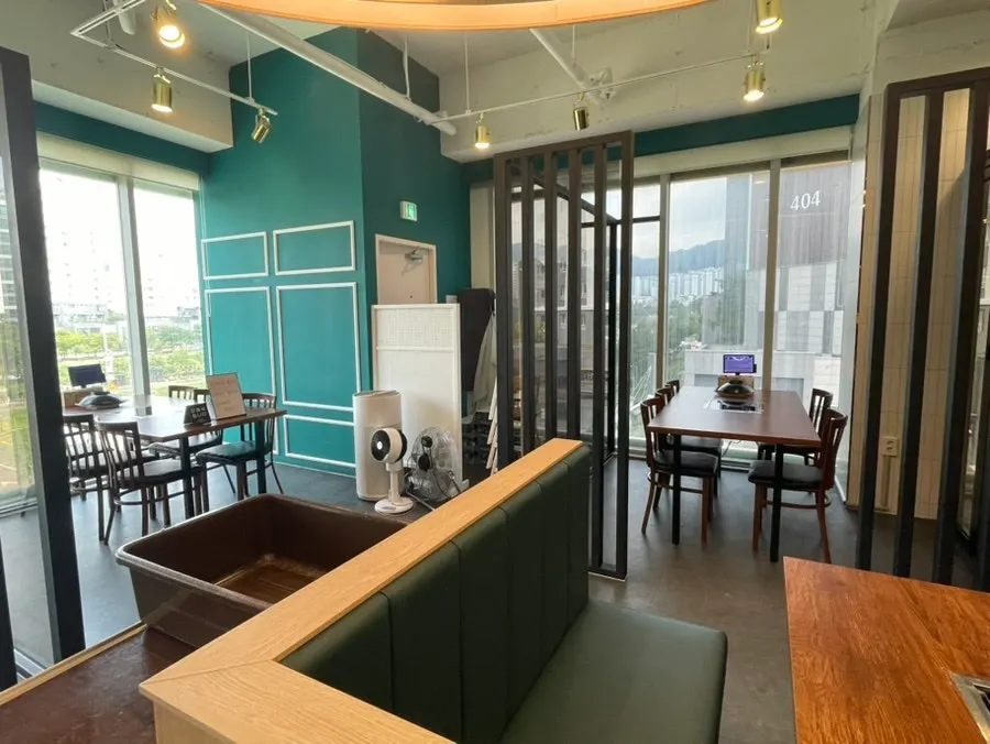 Interior seating with green and wood-tone partitions