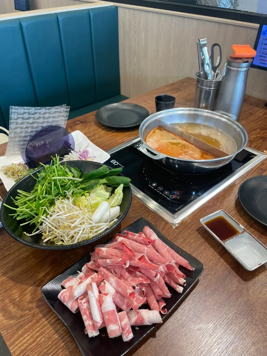 Pot of shabu-shabu with vegetables added to boiling broth