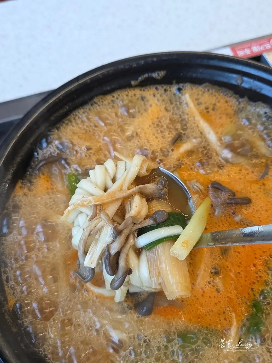 Noodles lifted with a ladle