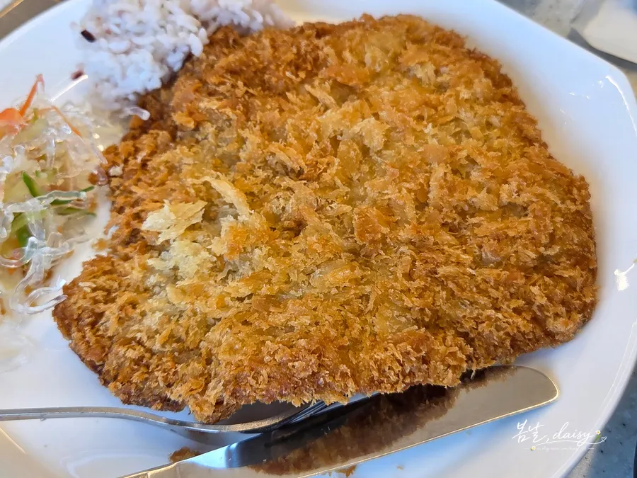 Cross-section of the pork cutlet with angel hair salad