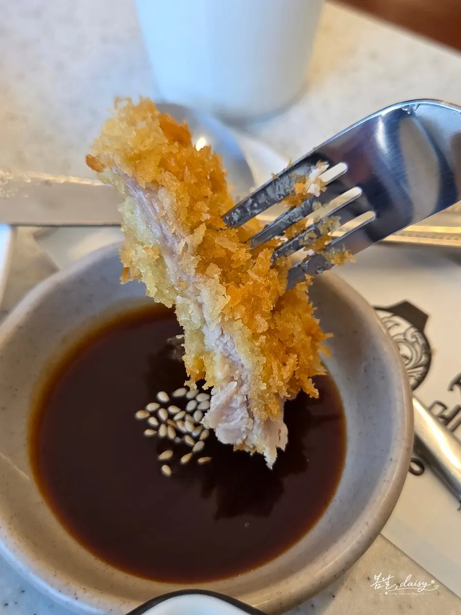 A piece of pork cutlet dipped in sauce