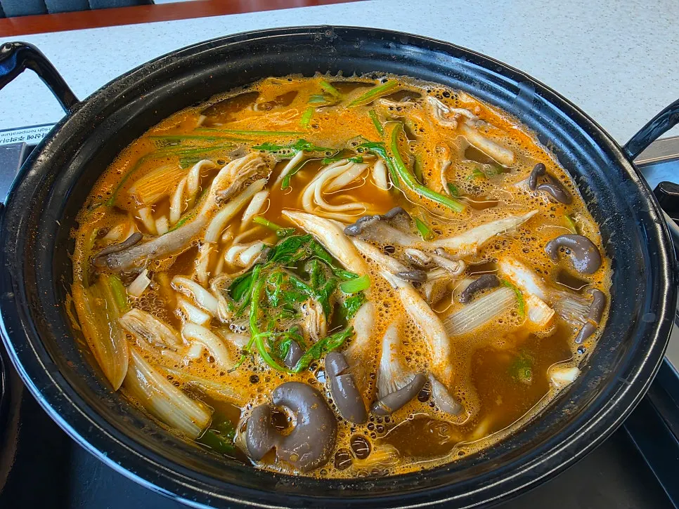 Table setup for boiling mushroom kalguksu at the table