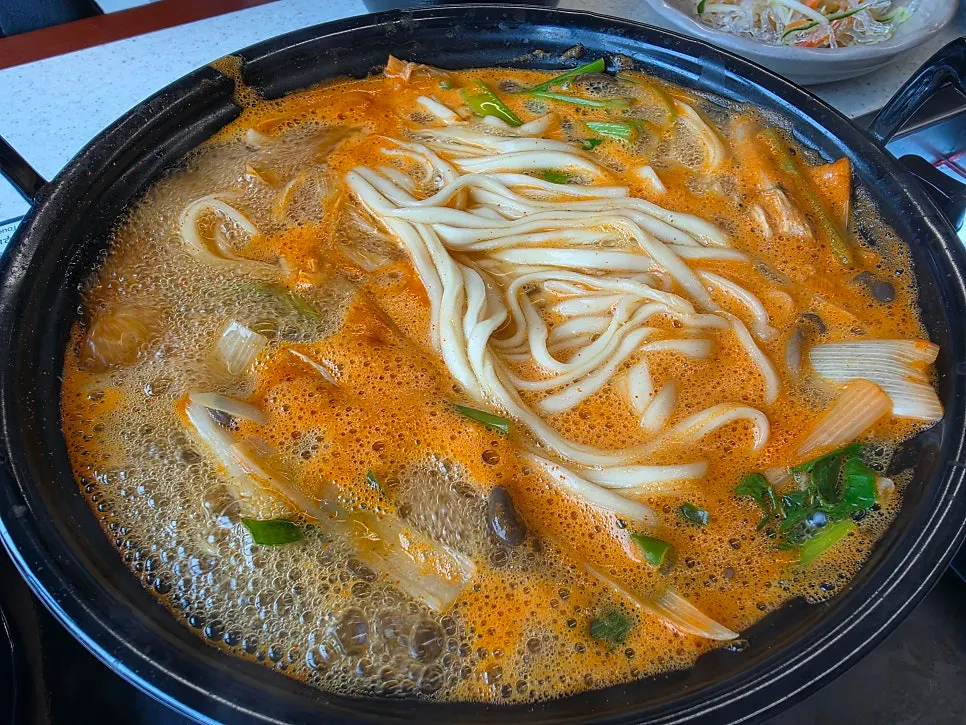 Mushroom kalguksu broth boiling vigorously