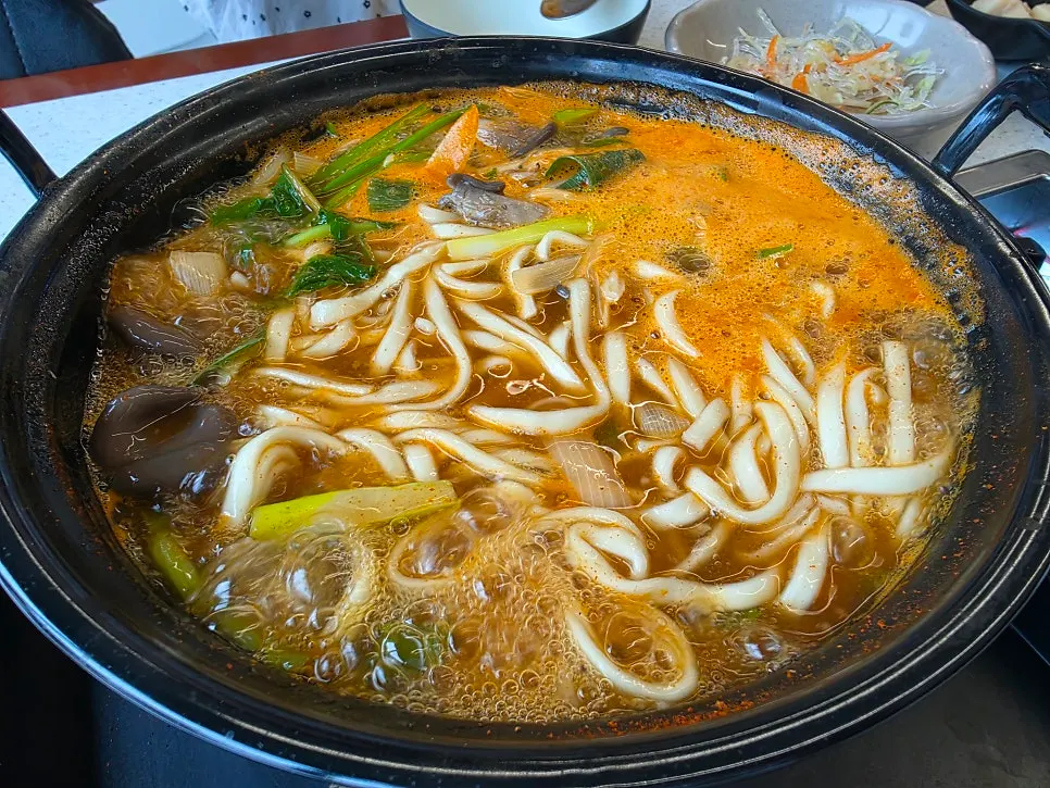Kalguksu noodles added and simmered in the broth