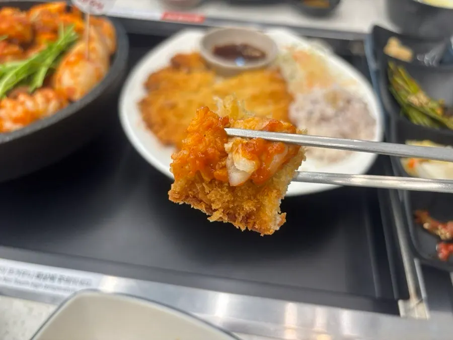 A piece of pork cutlet coated in seafood stew sauce