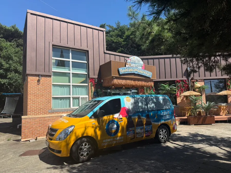 Entrance of Daecheon Brewery with a van painted with beer graphics