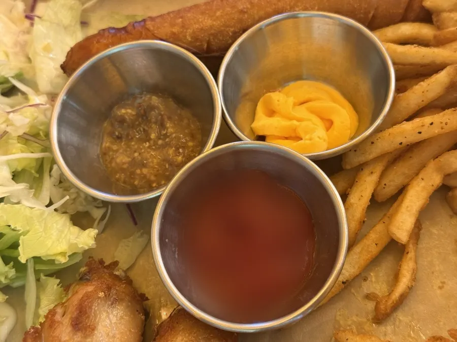 Three sauces: nacho sauce, ketchup, and whole grain mustard