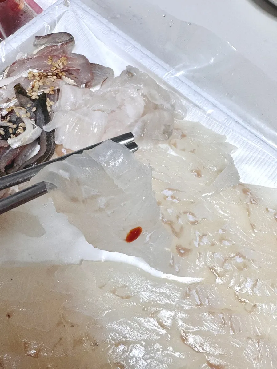 Flounder sashimi being packed into a container