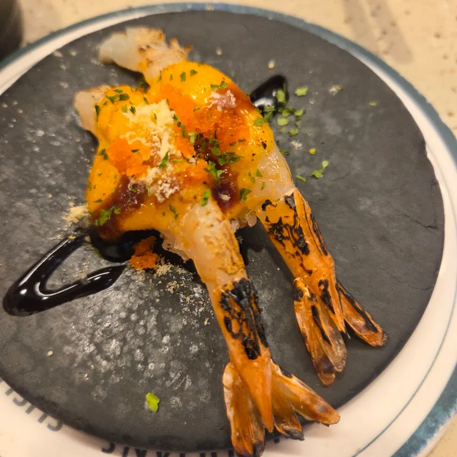 A plate of grilled king prawn sushi