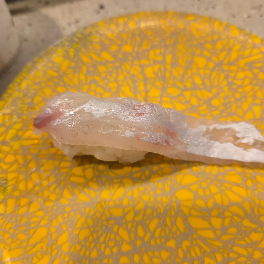 Red seabream belly sushi with a long slice of fish