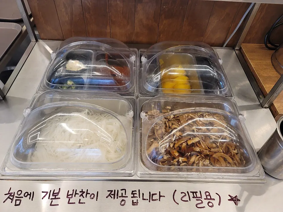Wall at Daedae Myeonok showing TV appearance clips