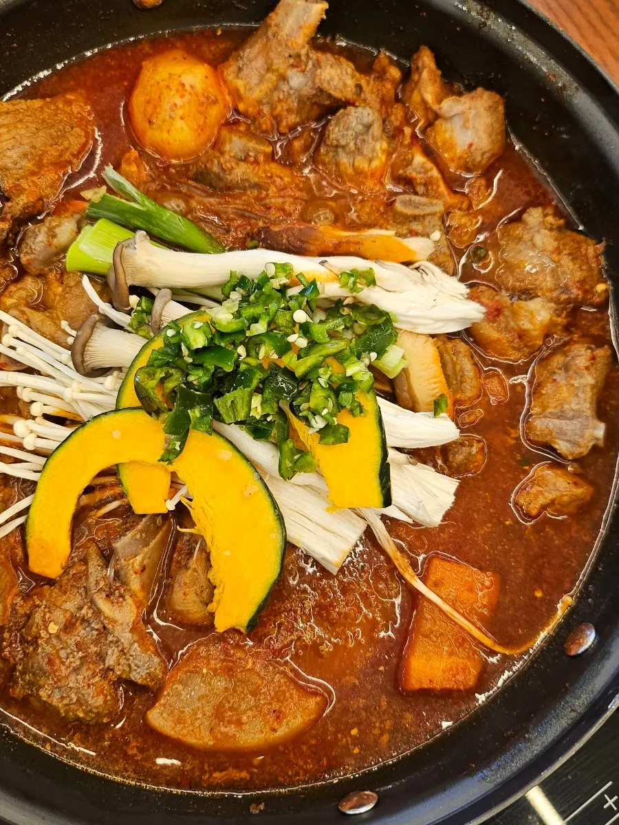Spicy galbijjim table setting with vegetables on top