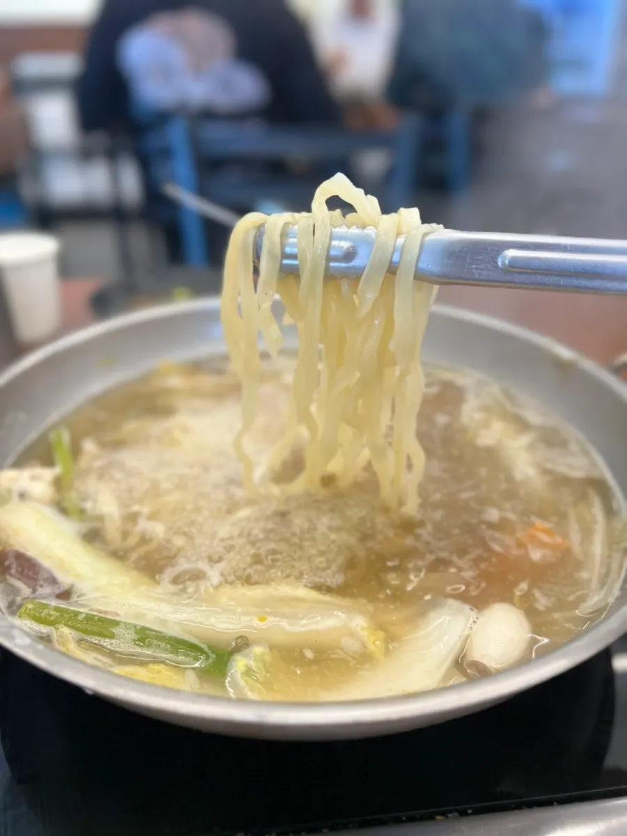 Kalguksu noodles cooked in the hot pot broth