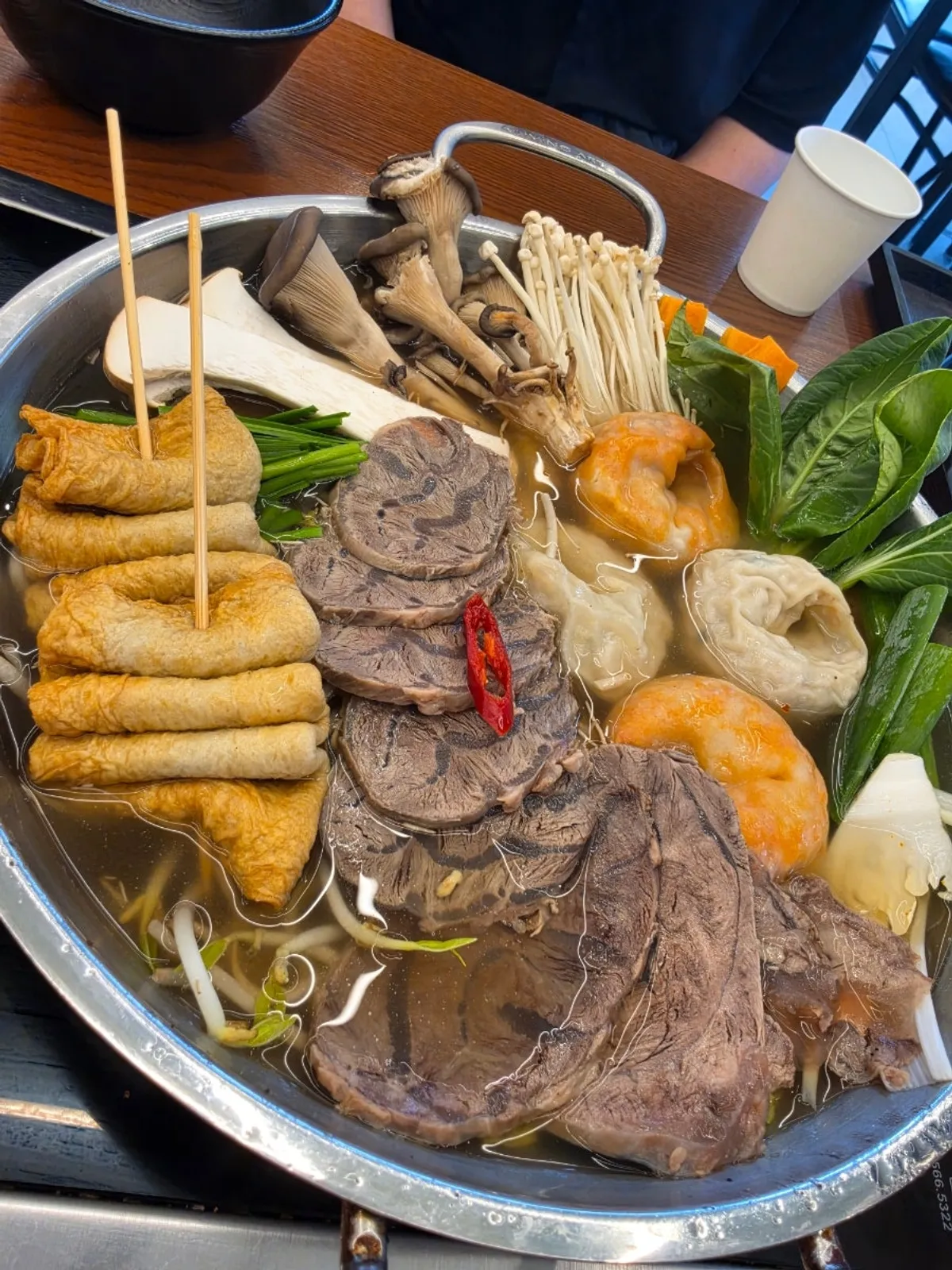 A pot of mandu jeongol filled with vegetables and dumplings