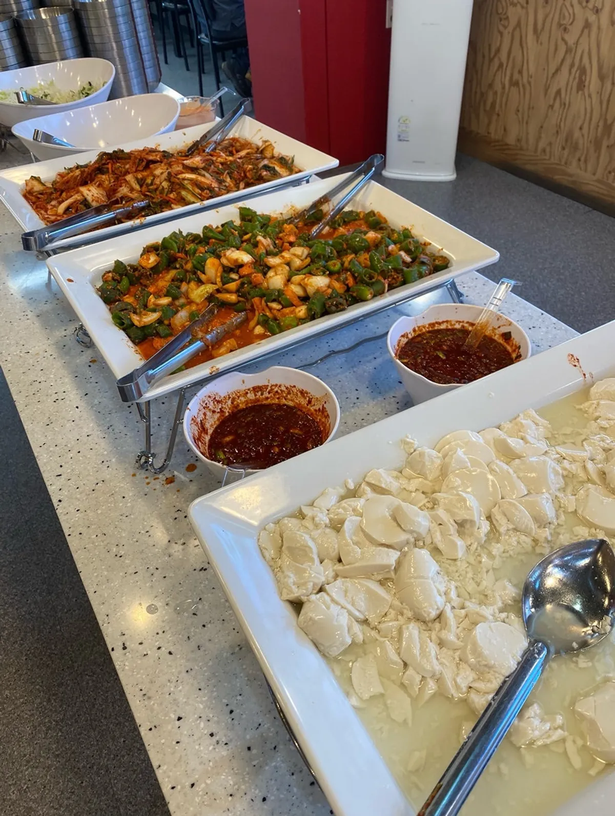 Side dish tray fully stocked with jjolmyeon and japchae