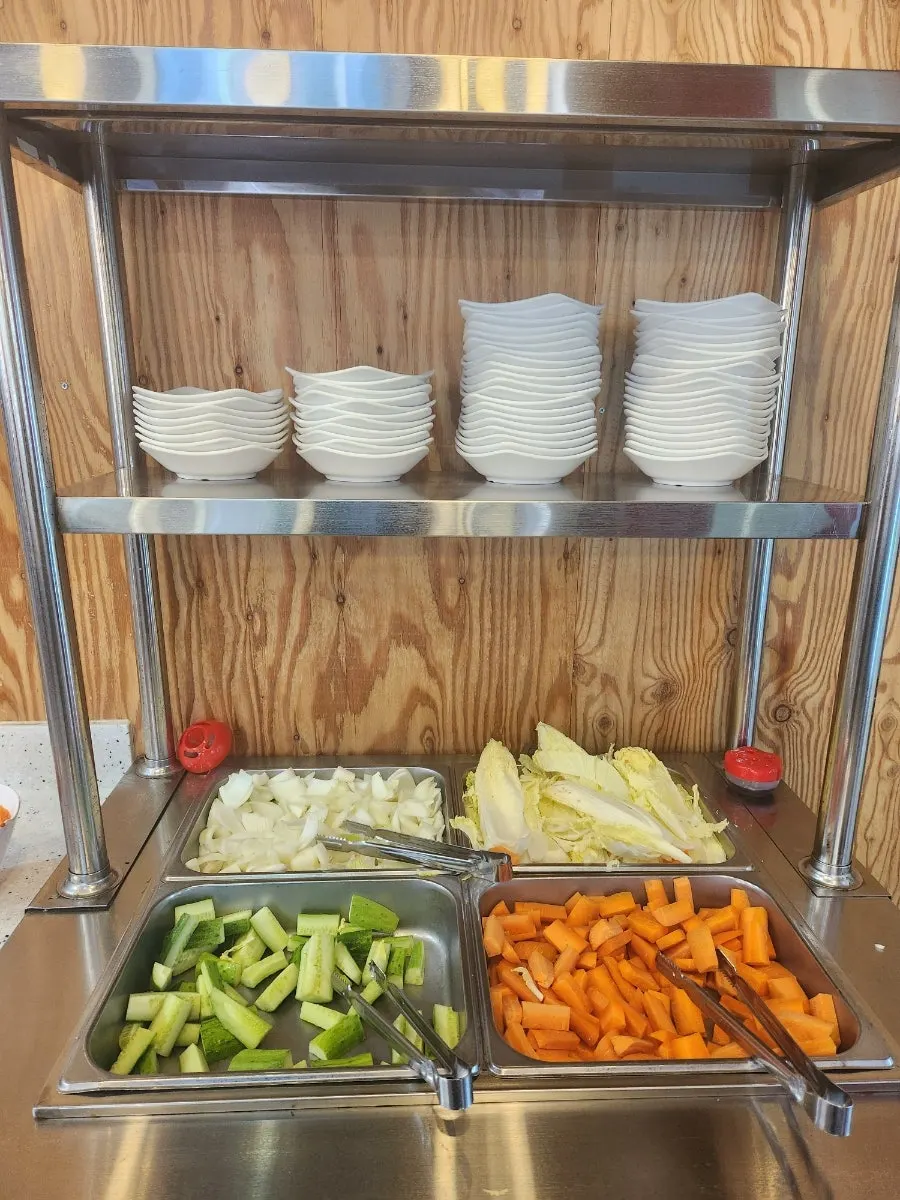 Self-serve corner with basic vegetables and small plates