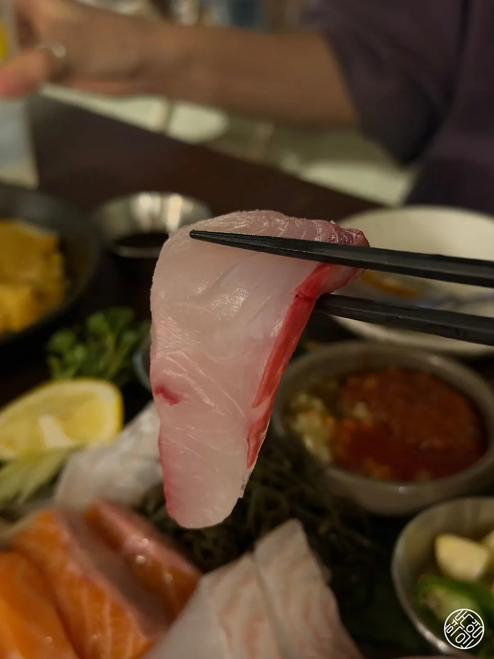A wrap of seaweed with aged sashimi and baek-kimchi
