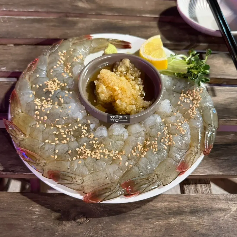 A plate of Daegang's shelled seasonal raw shrimp sashimi