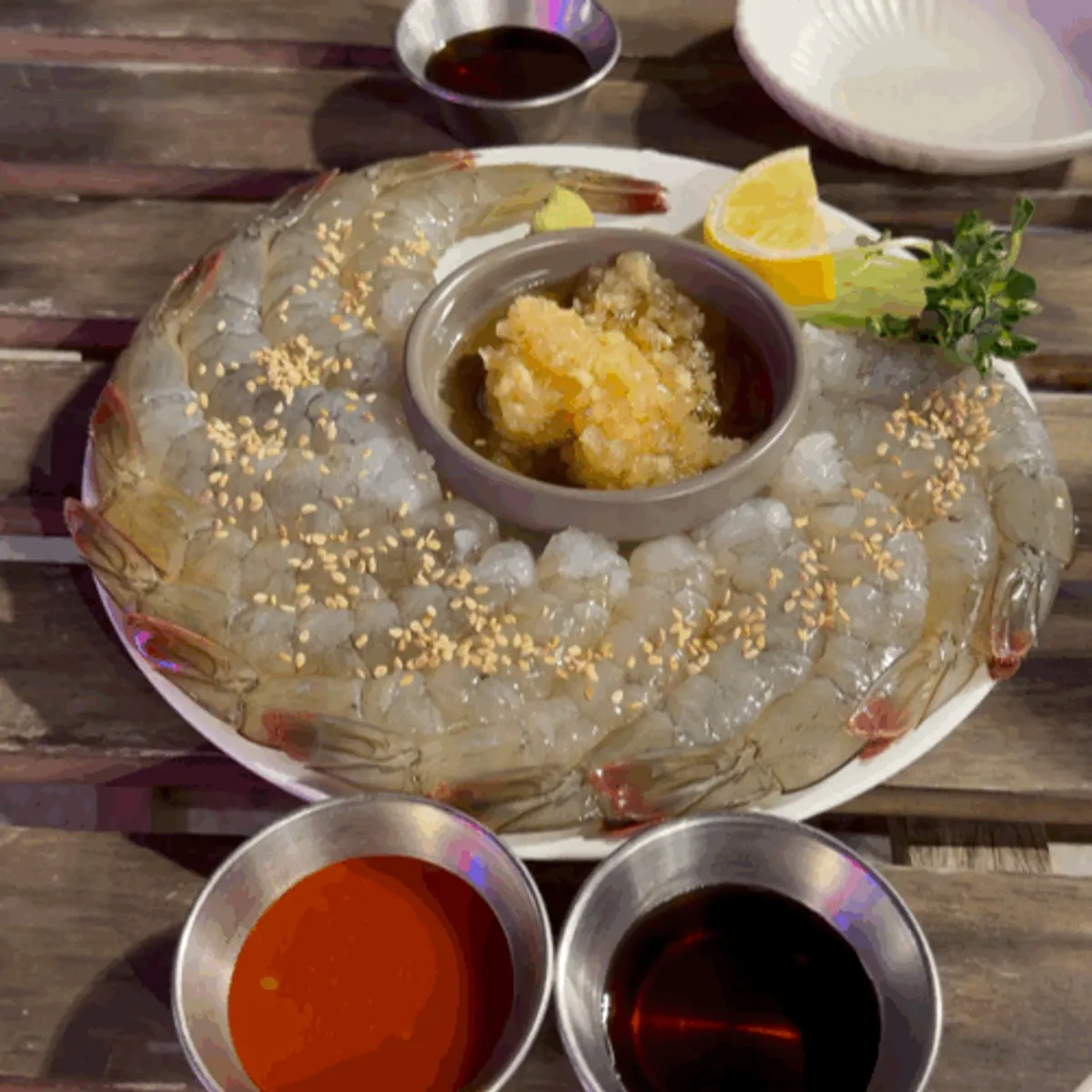 Raw shrimp sashimi dipped in sesame oil garlic sauce